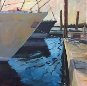 Two boats docked at a pier with sunlight reflecting on the water and ropes securing them.